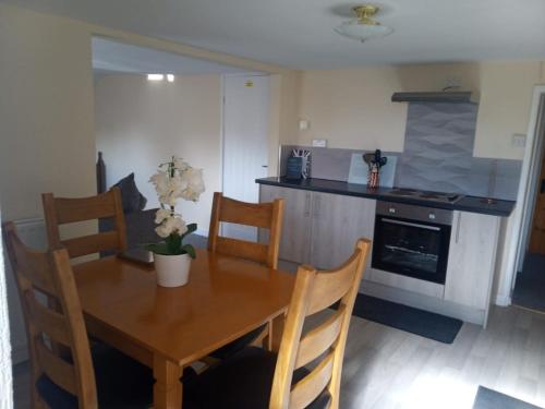 a kitchen with a wooden table with chairs and a dining room at Fox and Hounds Apartment in Willingham