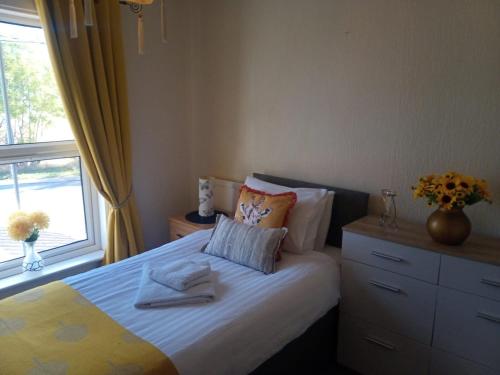 a small bedroom with a bed with a window at Fox and Hounds Apartment in Willingham