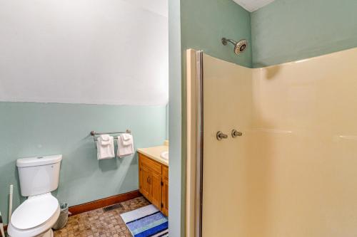 a bathroom with a toilet and a sink at Cozy Cabin in the Woods in Londonderry