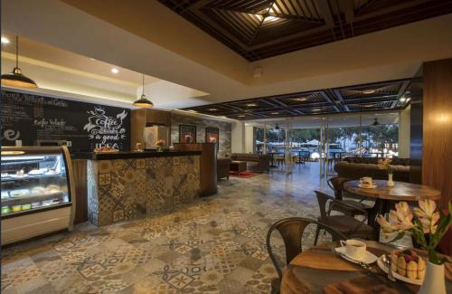 a restaurant with tables and chairs and a counter at Condo at Krystal Grand Resort in Bucerías