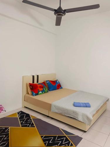 a bed in a room with a ceiling fan at D'Irish Homestay Wakaf Che Yeh in Kota Bharu