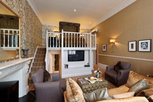 a living room with a fireplace and a television at The Colonnade in London