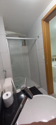 a bathroom with a sink and a mirror at ILOA Ap inteiro - 2 suites sala cozinha in Barra de São Miguel