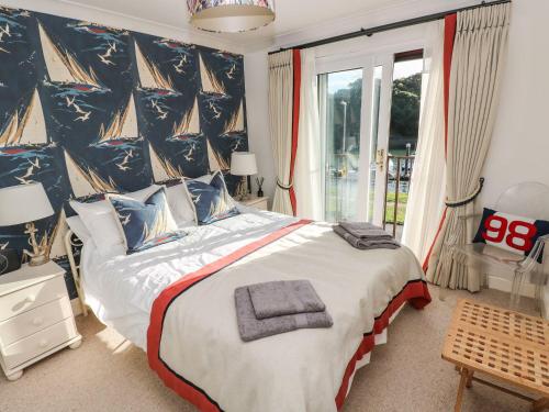 a bedroom with a large bed with a pirate themed wall at Yacht Haven View in Milford Haven