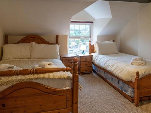 a bedroom with two twin beds and a window at Glasfryn in Dolgellau