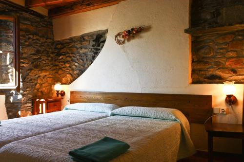 En eller flere senge i et værelse på Hostal Rusó SC