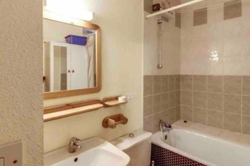 Un baño con lavabo, bañera y espejo. en Baréges : Appartement Résidence de l’Ayré, en Barèges