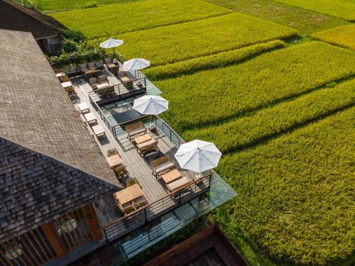 an aerial view of a house with tables and umbrellas at Kappa Senses Ubud in Ubud
