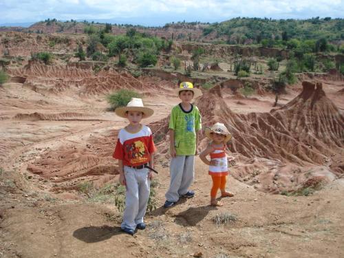 grupa trzech dzieci stojących na pustyni w obiekcie CASA FLOR DE LIZ w mieście Villavieja