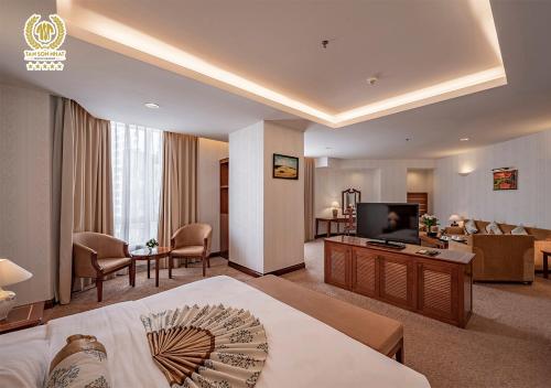 a hotel room with a bed and a television at Tan Son Nhat Saigon Hotel in Ho Chi Minh City