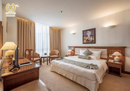 a hotel room with a bed and a television at Tan Son Nhat Saigon Hotel in Ho Chi Minh City