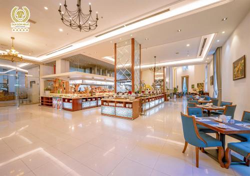 a dining room with tables and chairs and a restaurant at Tan Son Nhat Saigon Hotel in Ho Chi Minh City