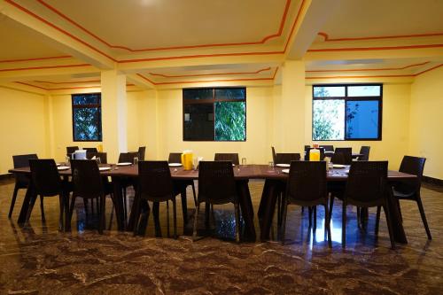 a large dining room with a table and chairs at Hotel White Lotus Gangtok in Gangtok