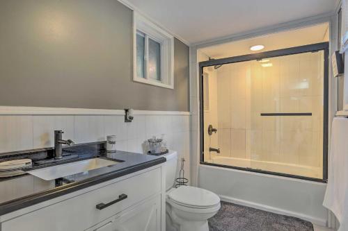 a bathroom with a toilet and a sink and a shower at Stunning South Fallsburg Home with Pool and Deck! in South Fallsburg