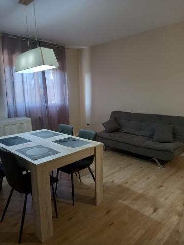 a living room with a table and a couch at Le dimore di Billa in La Martella