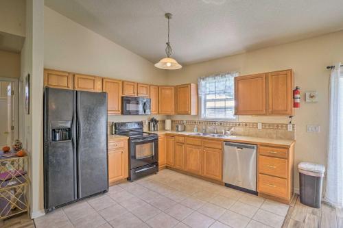 a kitchen with wooden cabinets and stainless steel appliances at Sebring Gem Close to Golf and Raceway in Sebring