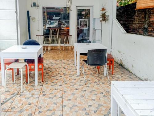 2 mesas blancas y sillas en un patio en Homestay Awal Fajar Syariah Bulukumba, en Bulukumba