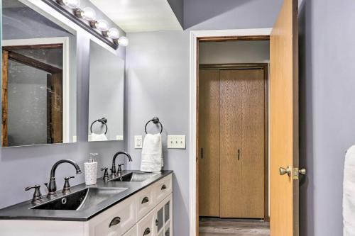 a bathroom with two sinks and a mirror at Cozy Duplex Close to Toledo Botanical Garden in Toledo