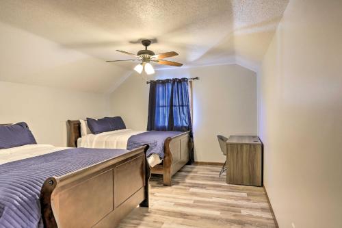 a bedroom with two beds and a ceiling fan at Cozy Duplex Close to Toledo Botanical Garden in Toledo
