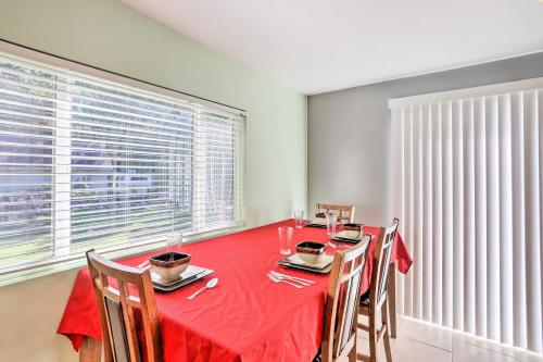 a dining room with a red table and chairs at Family-Friendly Toledo Retreat with Spacious Yard! in Toledo