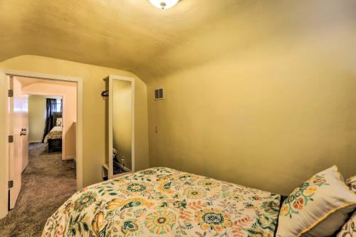 a bedroom with a bed with a floral bedspread at Family-Friendly Toledo Retreat with Spacious Yard! in Toledo