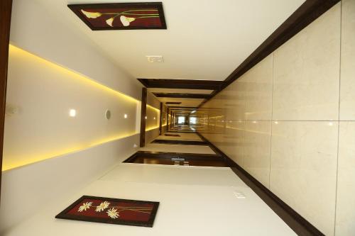 a stairway with paintings on the walls of a building at WEST FORT HOTEL in Bengaluru