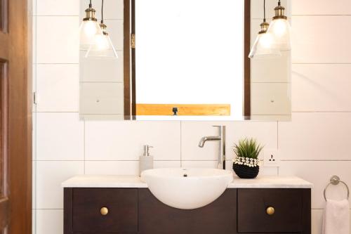 a bathroom with a sink and a mirror at Villa Toru - Stylish luxury in Legian, tranquil location, walk to beach in Legian