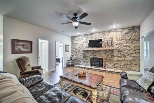 a living room with a couch and a stone fireplace at Near Sugar Mtn Resort! Mtn-View Outdoor Basecamp in Banner Elk