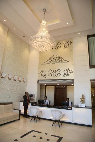 a lobby with a reception desk in a hotel at WEST FORT HOTEL in Bengaluru