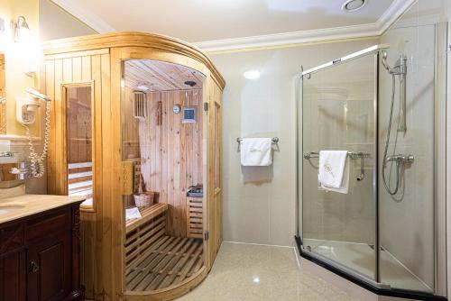a bathroom with a shower and a glass shower stall at La Contessa Castle Hotel in Szilvásvárad