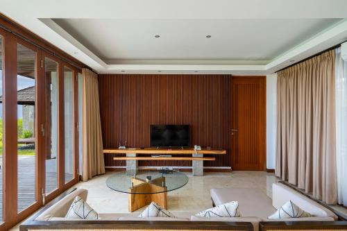 a living room with a couch and a table at Moritz Palm Villa in Uluwatu