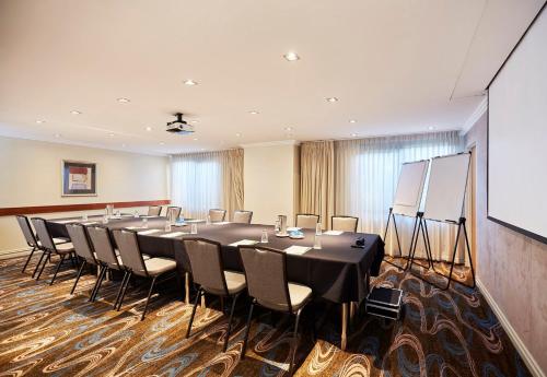 a conference room with a long table and chairs at Holiday Inn Parramatta by IHG in Sydney