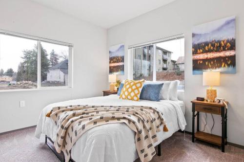 a white bedroom with a bed and two windows at Full ADA Unit - 2 Bed 2 Bath Unit Near Downtown in Spokane