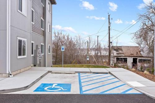 a handicapped sign on a sidewalk next to a building at Full ADA Unit - 2 Bed 2 Bath Unit Near Downtown in Spokane