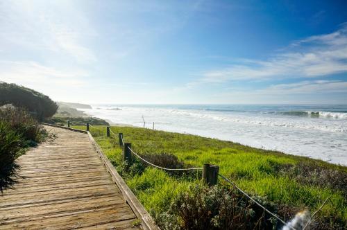 a wooden path leading down to the beach at Blue Dolphin Inn in Cambria