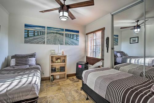 a bedroom with two beds and a ceiling fan at Carlsbad Getaway - Furnished Patio and Pool! in Carlsbad