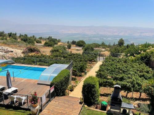 a villa with a swimming pool on a hill at Vibe Naftali Estate in Ramot Naftali