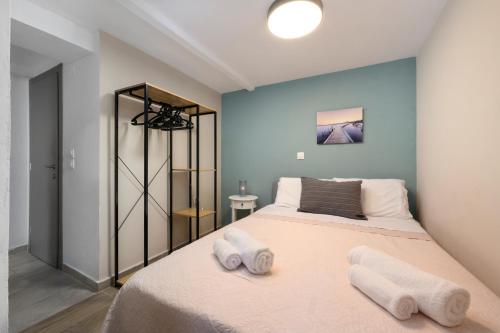 a bedroom with a bed with two towels on it at Ileana-Marina studio 1 in Benitses