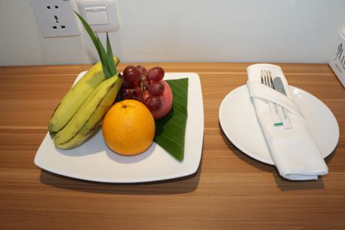 a plate with fruit on top of a table at Horison Sentani in Ifaar