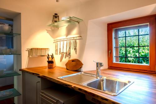 a kitchen with a sink and a window at Karst house Žan Pliskovica in Dutovlje