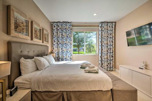 a bedroom with a large bed and a window at Upscale Townhome Close to Walt Disney World! in Orlando