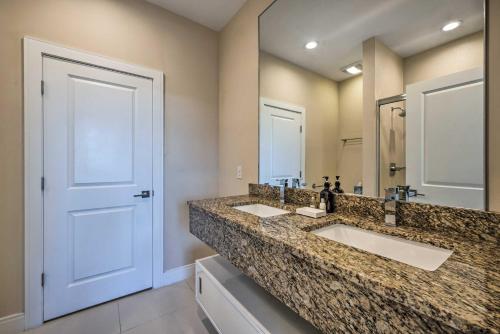 a bathroom with two sinks and a large mirror at Upscale Townhome Close to Walt Disney World! in Orlando