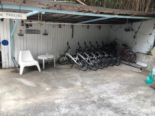 a group of bikes parked in a garage at Bamboo Village Guest House in Naoshima