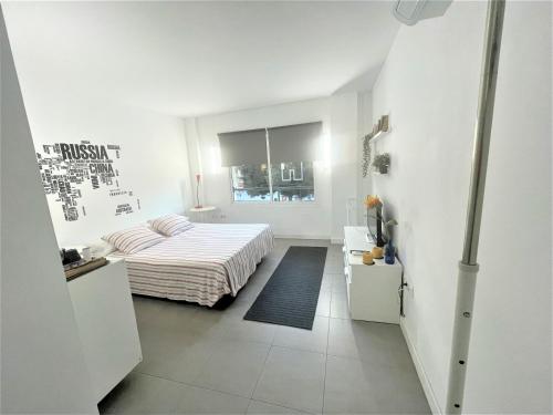 biała sypialnia z łóżkiem i oknem w obiekcie Plaza de toros / Centro w Maladze