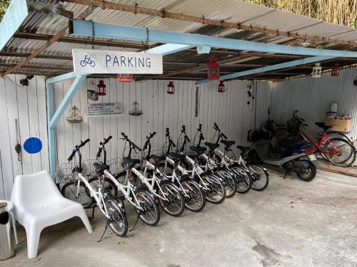 a bunch of bikes parked in a garage at Bamboo Village Guest House in Naoshima