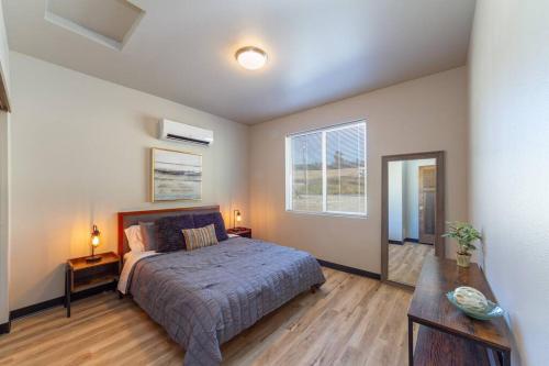 a bedroom with a bed and a table and a window at Wonderful Triplex Unit With Spectacular Lake View! in Valley