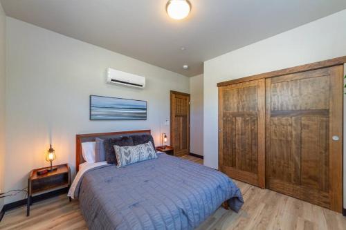 a bedroom with a bed and a large wooden closet at Gorgeous Triplex Unit With Spectacular Lake Views! in Valley