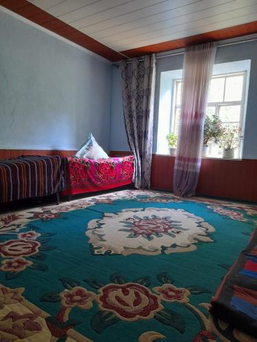 a living room with a couch and a rug at Guest house Shairkul in Kyzylunkyur