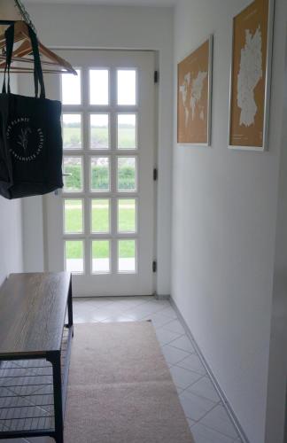 a room with a window and a table and a door at Schöne Wohnung mit Terrasse & Blick ins Grüne in Dormettingen