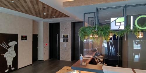 a lobby of a restaurant with a sign on the wall at ICI HOTEL Ueno Shin Okachimachi in Tokyo